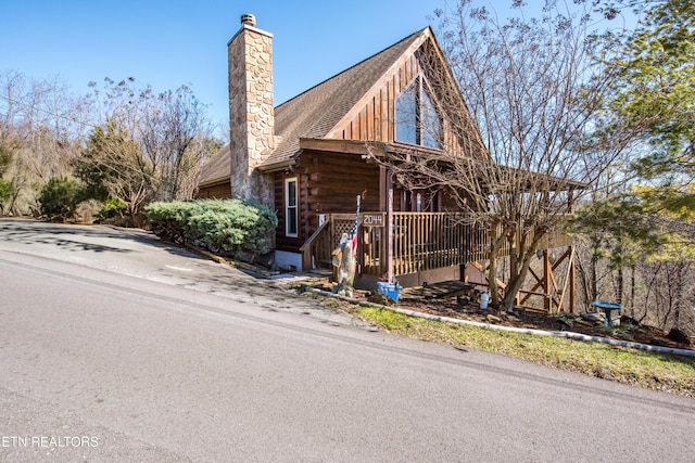 log home featuring a chimney and log exterior