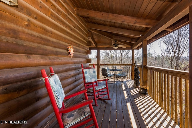 wooden terrace with ceiling fan and outdoor dining area