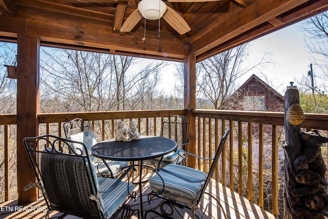 wooden terrace featuring ceiling fan and outdoor dining area