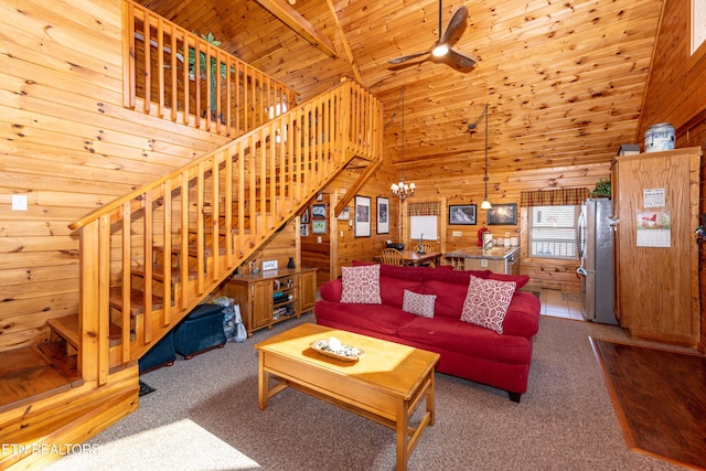 living area featuring stairway, wood walls, carpet, and wood ceiling