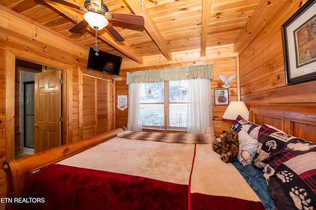 bedroom with beamed ceiling, wood ceiling, and wooden walls