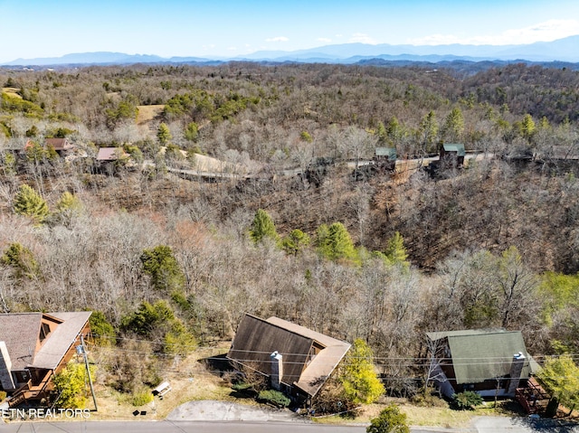 aerial view with a wooded view and a mountain view