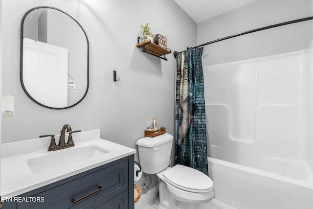 bathroom featuring vanity, toilet, and shower / bath combo with shower curtain