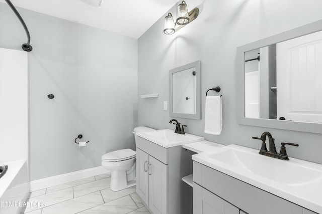 full bath with marble finish floor, a sink, toilet, and baseboards