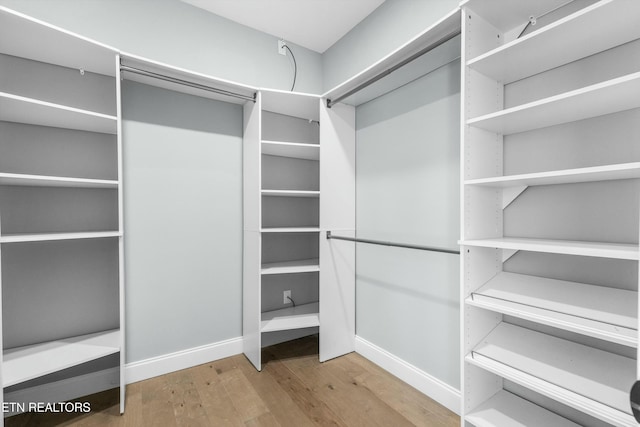 spacious closet with wood finished floors