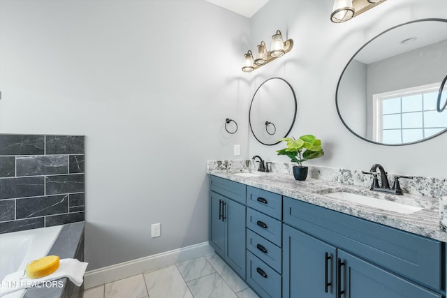 bathroom featuring double vanity, a sink, a tub, and baseboards