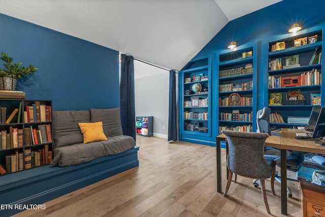 office area featuring built in features, vaulted ceiling, and wood finished floors