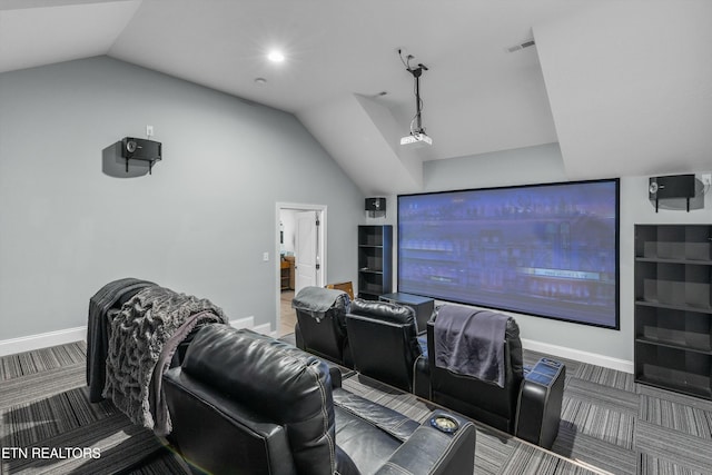 carpeted cinema room with visible vents, vaulted ceiling, and baseboards