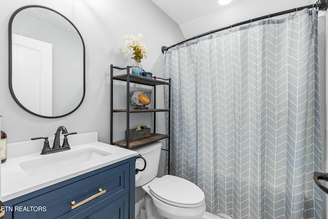 full bath featuring toilet, a shower with shower curtain, and vanity