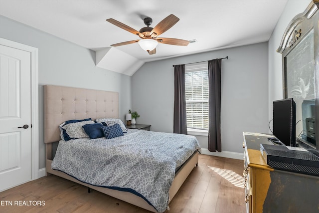 bedroom with baseboards, ceiling fan, and light wood-style floors