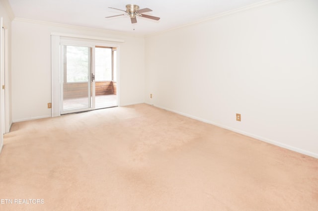 empty room featuring ceiling fan, baseboards, light colored carpet, and ornamental molding