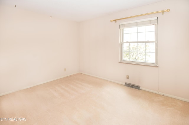 carpeted empty room with visible vents and baseboards