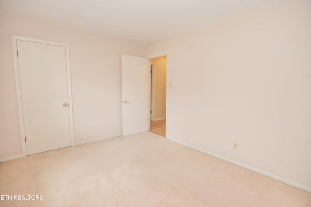 unfurnished bedroom with carpet and baseboards