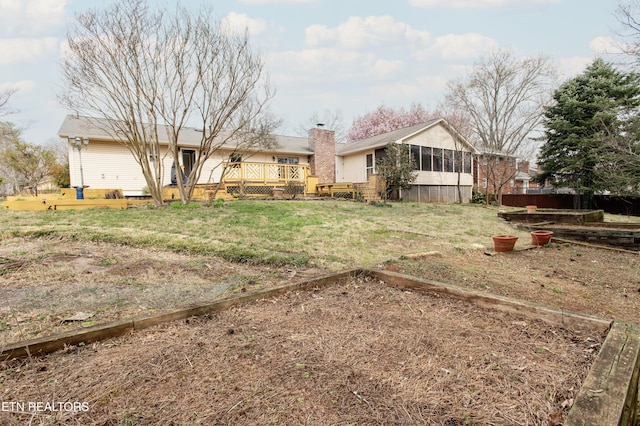 view of yard with a deck and a sunroom