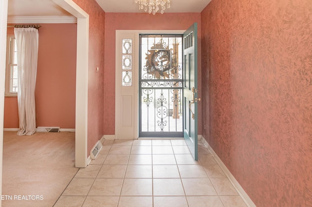 entryway featuring light tile patterned floors, baseboards, visible vents, wallpapered walls, and a chandelier