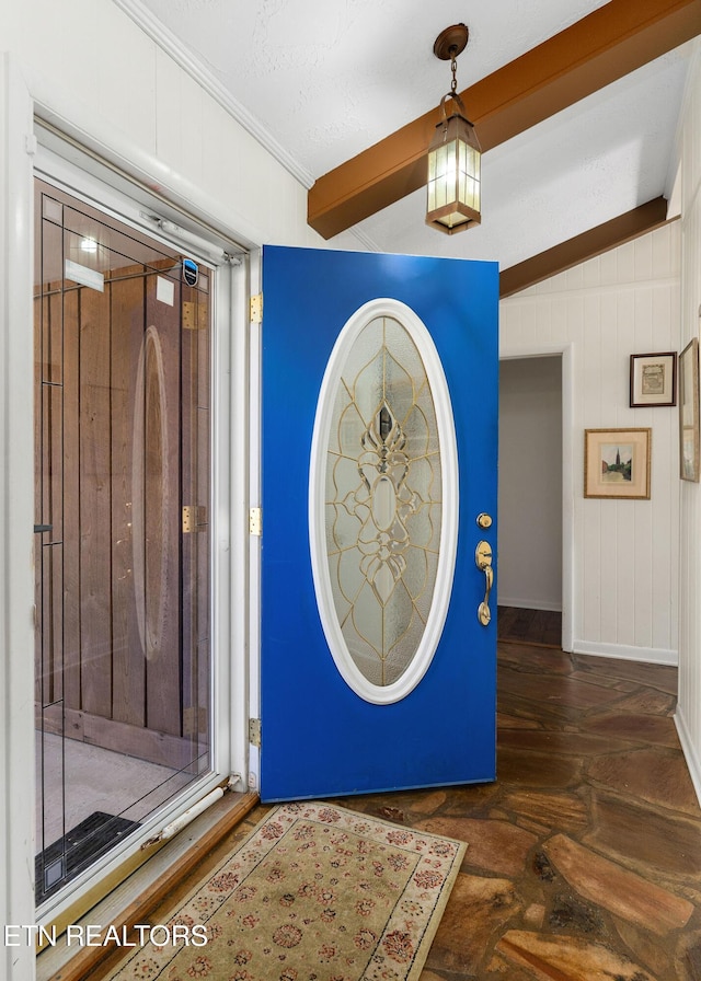 foyer entrance featuring ornamental molding and baseboards