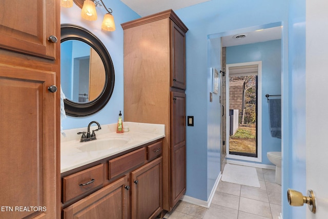 bathroom featuring baseboards, visible vents, toilet, tile patterned floors, and vanity