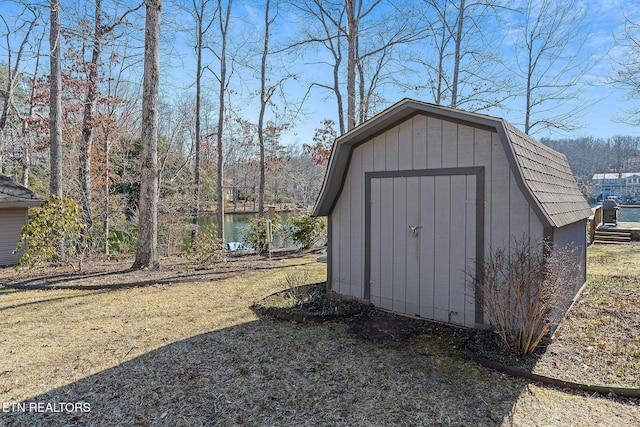 view of shed with a water view