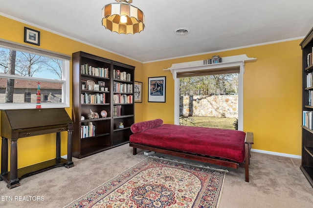 sitting room with baseboards, visible vents, ornamental molding, and light colored carpet