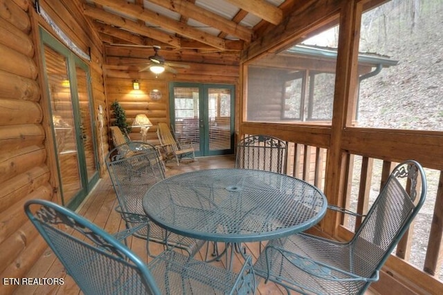 sunroom / solarium with vaulted ceiling with beams and french doors