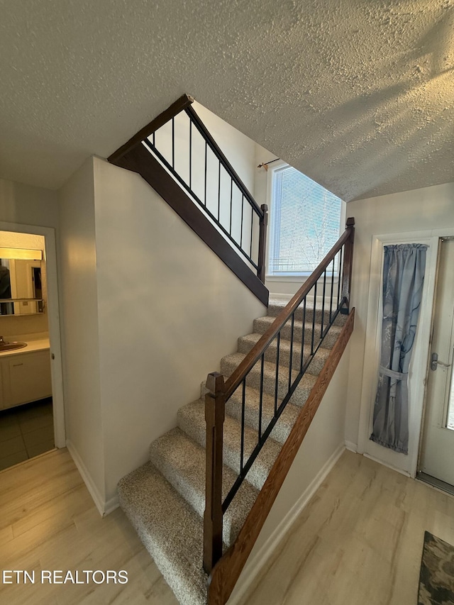 7000 Big Horn Dr Unit A-3, Crossville, TN 38572 - staircase with a textured ceiling, baseboards, and wood finished floors