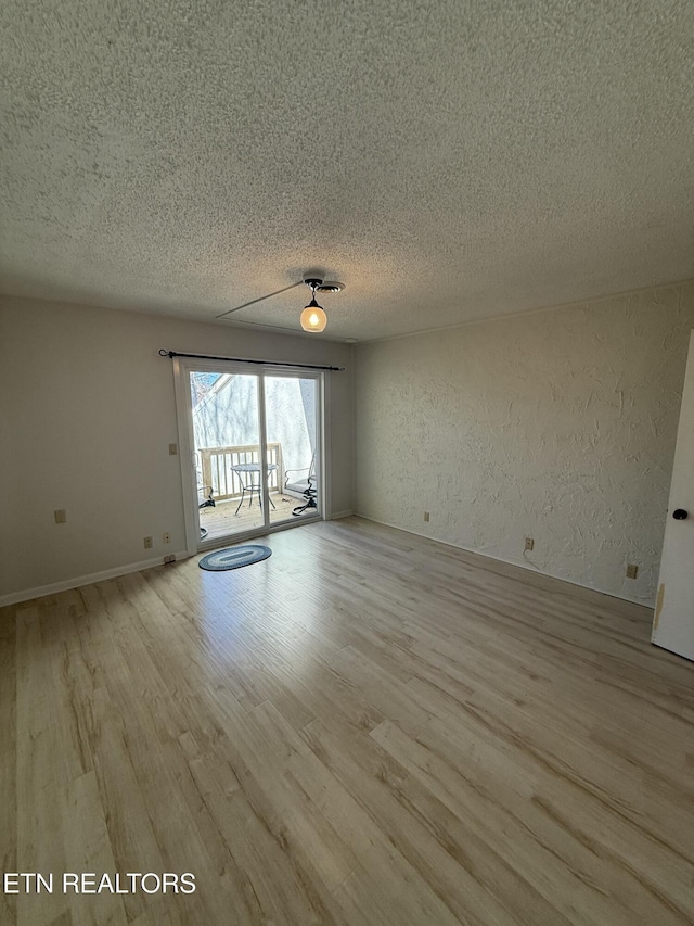 7000 Big Horn Dr Unit A-3, Crossville, TN 38572 - unfurnished room featuring a textured ceiling, a textured wall, and light wood-style flooring