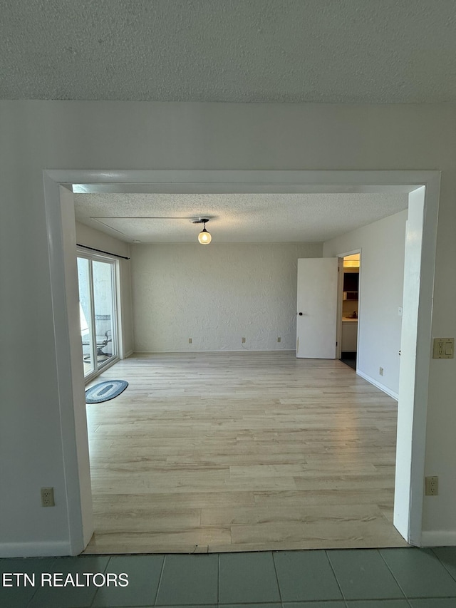 7000 Big Horn Dr Unit A-3, Crossville, TN 38572 - unfurnished room with light wood-style flooring, a textured ceiling, and baseboards
