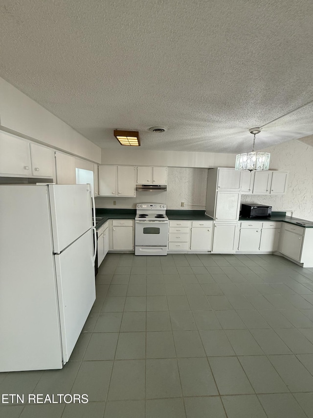 7000 Big Horn Dr Unit A-3, Crossville, TN 38572 - kitchen with white appliances, an inviting chandelier, white cabinets, dark countertops, and pendant lighting