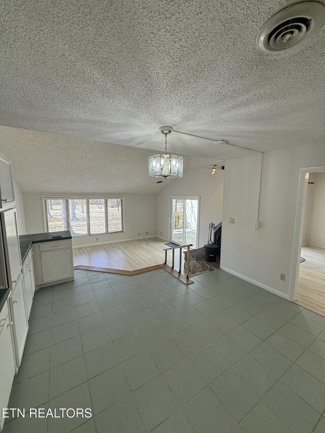 7000 Big Horn Dr Unit A-3, Crossville, TN 38572 - interior space featuring lofted ceiling, a notable chandelier, visible vents, baseboards, and tile patterned floors