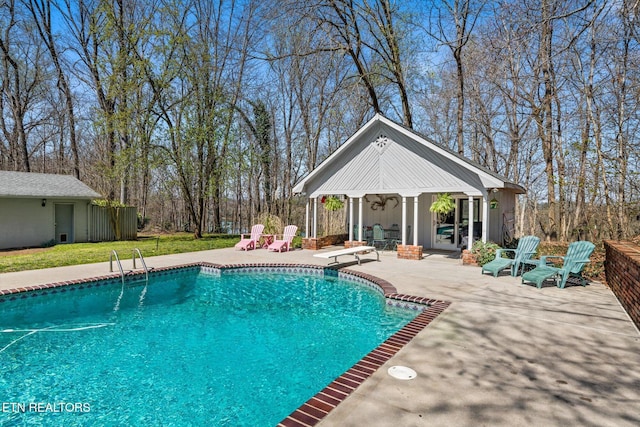 outdoor pool with a storage structure, a diving board, an outdoor structure, and a patio area