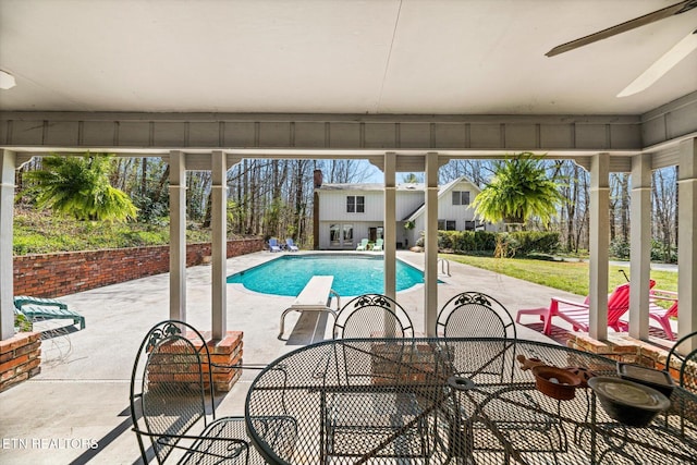 outdoor pool featuring outdoor dining space and a patio