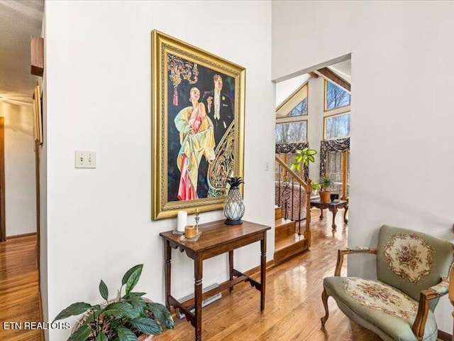 living area featuring stairway and wood finished floors