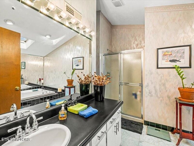 bathroom with vanity, a shower stall, and visible vents