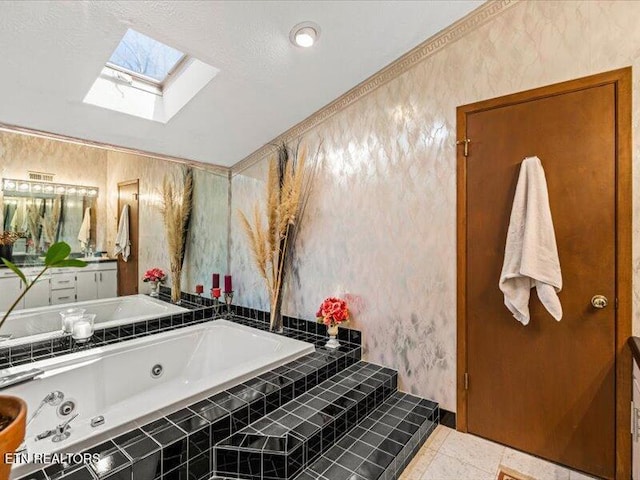 full bath with vanity, wallpapered walls, a skylight, a whirlpool tub, and tile patterned flooring