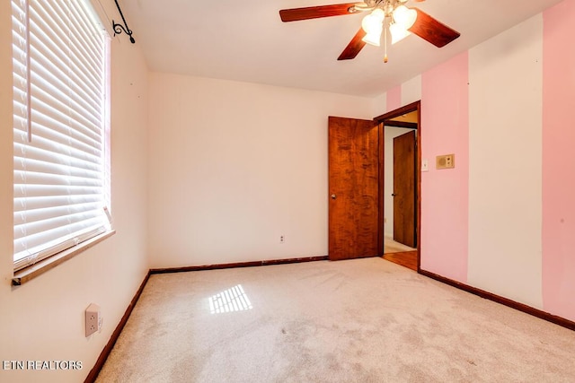 unfurnished bedroom with ceiling fan, baseboards, and light colored carpet