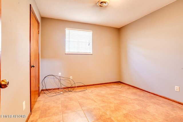 empty room featuring baseboards