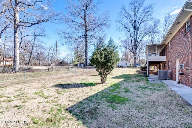 view of yard featuring central AC, fence private yard, and a sunroom