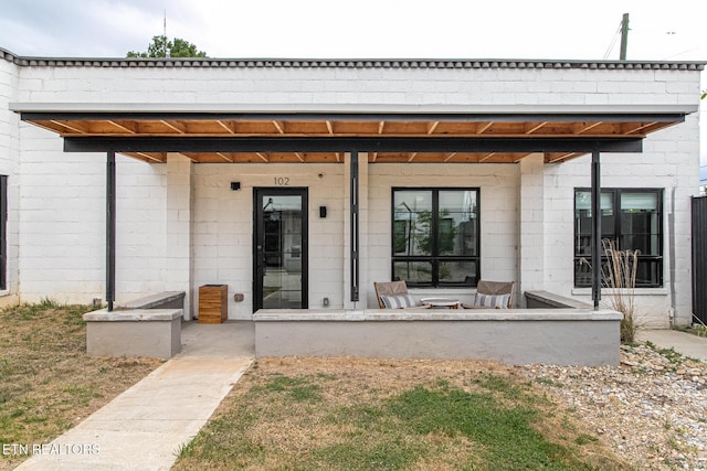 property entrance featuring concrete block siding