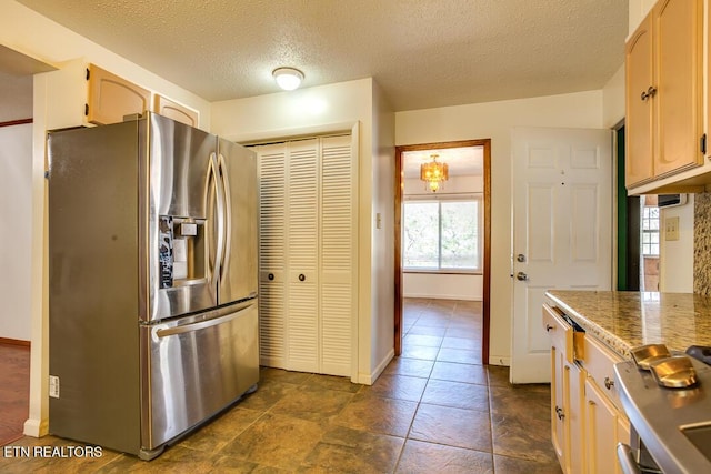 kitchen with light brown cabinets, baseboards, a textured ceiling, and stainless steel fridge with ice dispenser