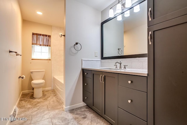 bathroom featuring visible vents, baseboards, toilet, vanity, and washtub / shower combination