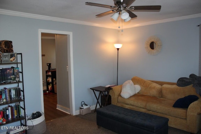 living room featuring baseboards, a ceiling fan, ornamental molding, and carpet flooring