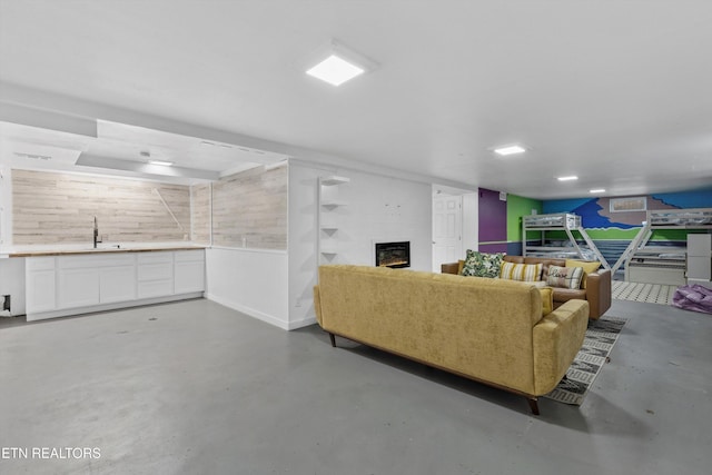 living area featuring concrete flooring and a fireplace