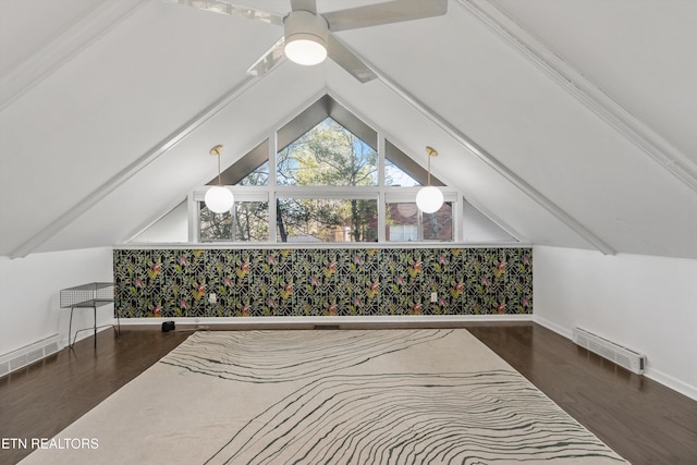 additional living space featuring lofted ceiling, visible vents, and wood finished floors