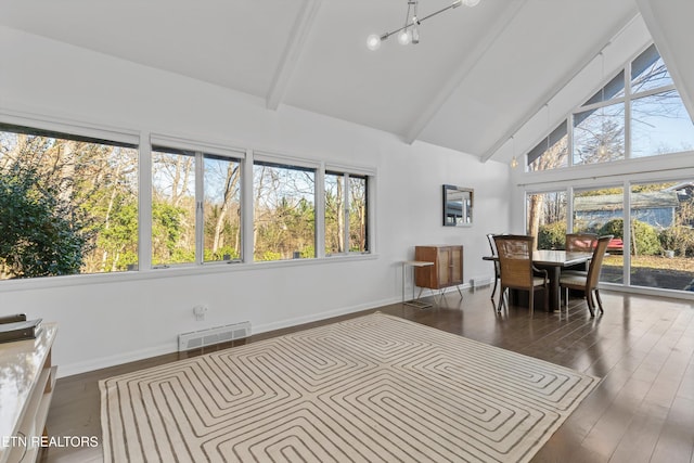 sunroom featuring vaulted ceiling with beams, a wealth of natural light, and visible vents