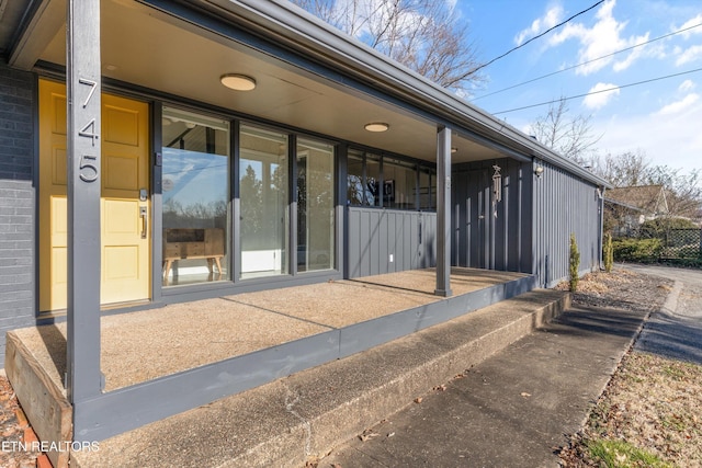 doorway to property featuring brick siding