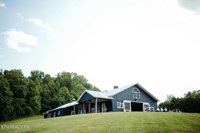 rear view of property featuring a yard