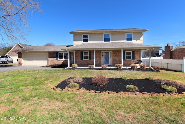 view of front of house featuring aphalt driveway, a porch, a garage, fence, and a front lawn