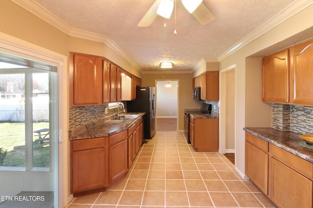 kitchen with light tile patterned floors, stainless steel appliances, brown cabinetry, ornamental molding, and a sink