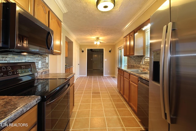 kitchen featuring electric range, a sink, dishwasher, brown cabinetry, and stainless steel fridge