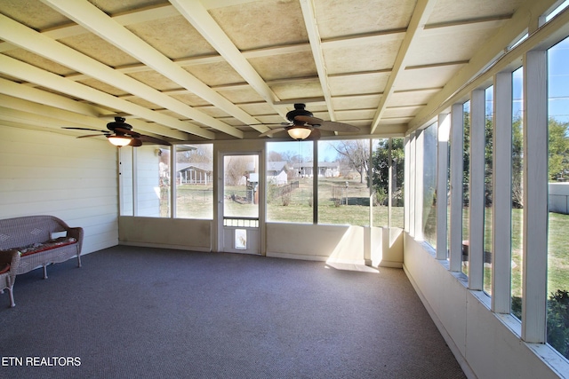 unfurnished sunroom featuring a wealth of natural light and ceiling fan